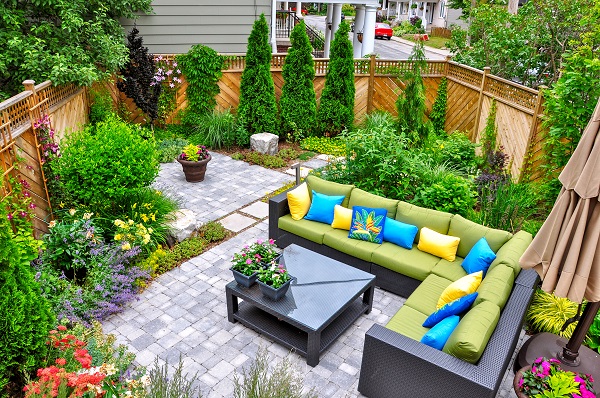 A small, urban garden favouring vibrant plant and furniture colour over lawn space