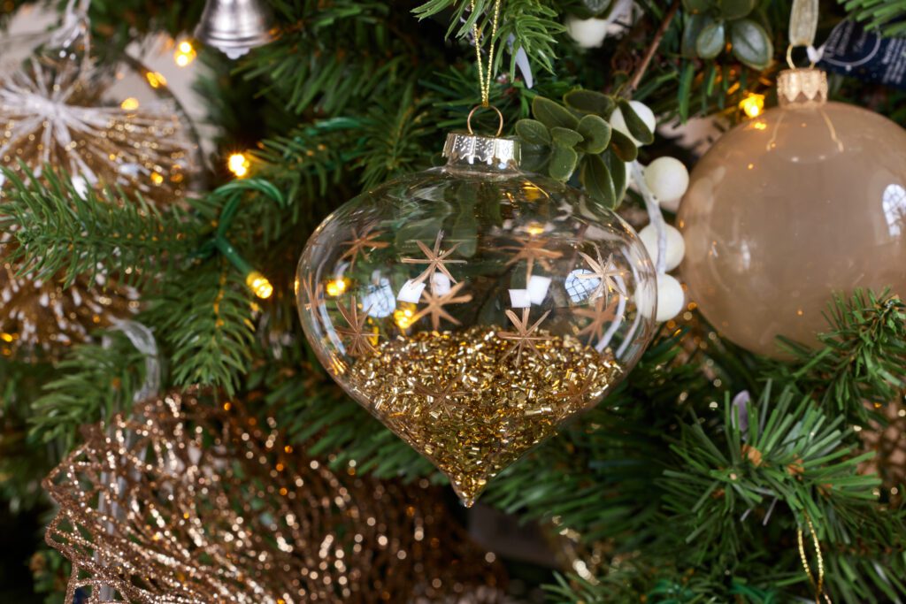 Glass hanging decoration filled with glitter